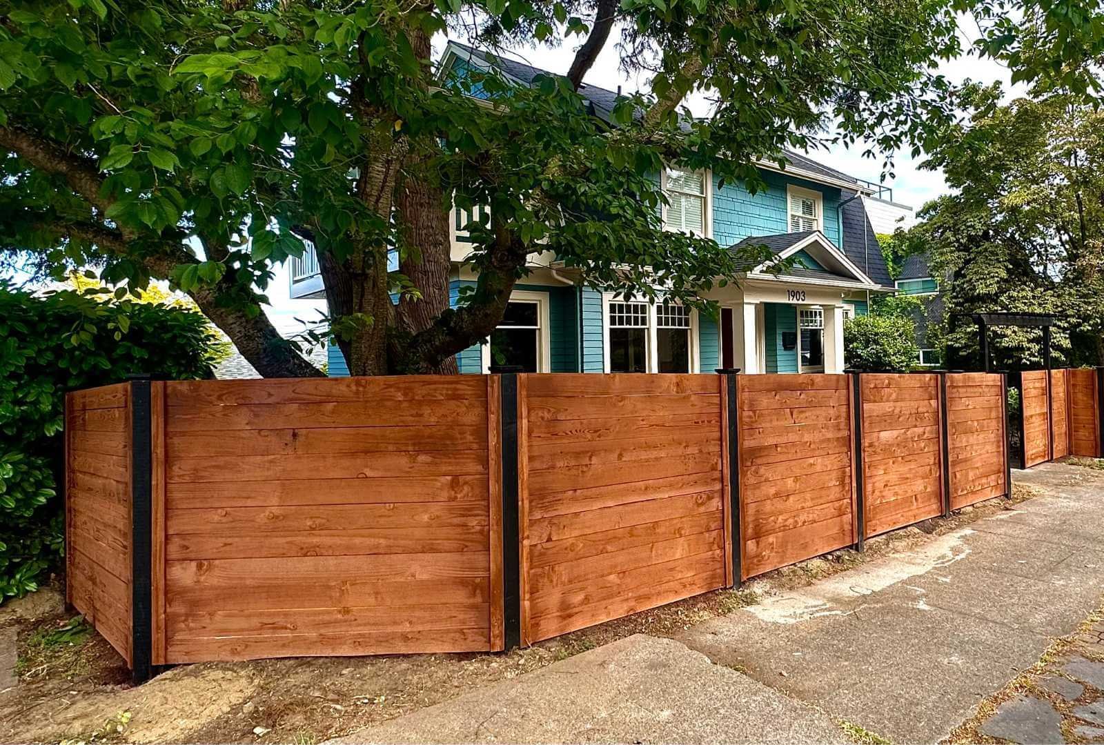 Runika.pro contractors professionally installing a sturdy wood fence on a residential property in Miami
