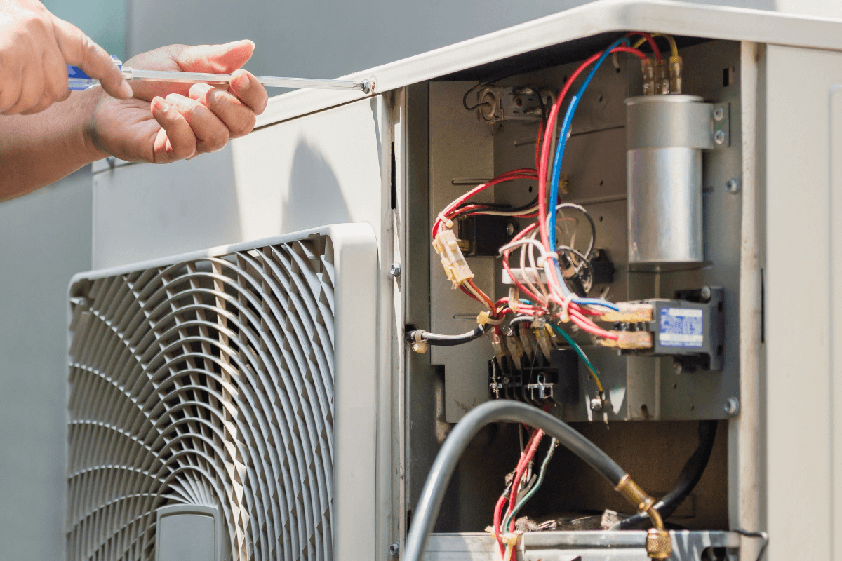 AC Tune-Up & Efficiency Repair Miami | Lower Bills, Better Cooling Runika.pro technician cleaning condenser coils or sealing ductwork to improve the efficiency of an AC system in Miami