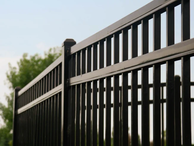 Runika.pro installation team building a tall, solid privacy fence around a backyard in Miami for security and seclusion