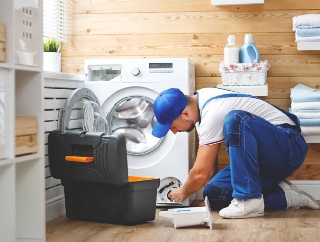 A Runika.pro appliance repair technician in Miami fixing a broken refrigerator or washing machine during a same-day service call