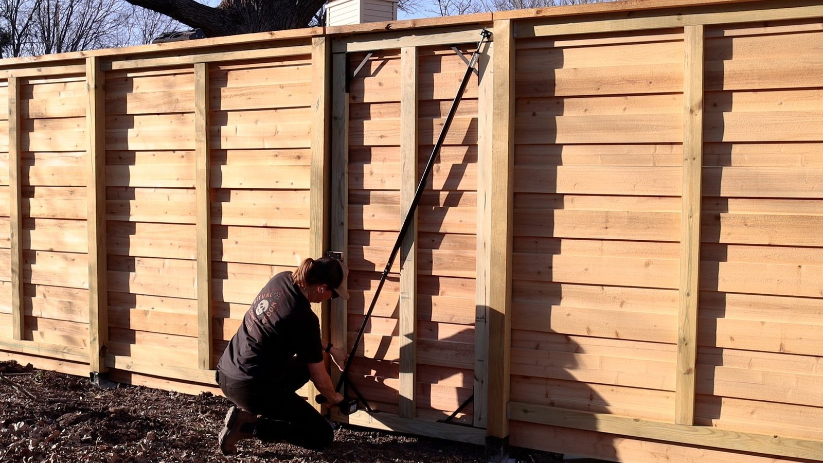 A classic white picket fence or elegant horizontal wood fence enhancing the curb appeal of a Miami home, built by Runika.pro