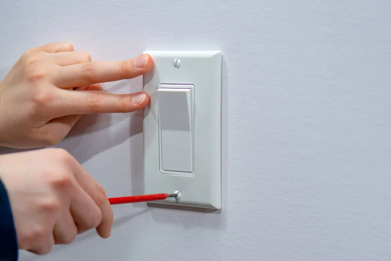 Light Switch Repair & Installation Miami | Safe Electrical Work | Runika.pro A licensed Runika.pro electrician in Miami carefully repairing or replacing a faulty light switch, ensuring safe and proper connections