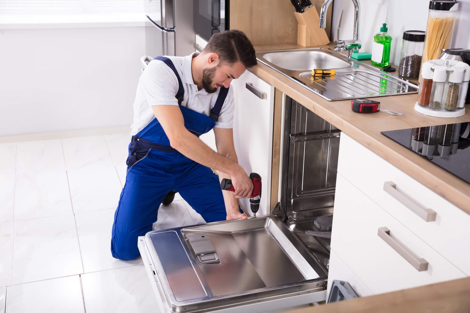 Complete Appliance Repair Services Miami | All Major Brands & Models Runika.pro repair specialist working on various appliances: a stove, a microwave, and a clothes dryer during a multi-appointment service in a Miami home