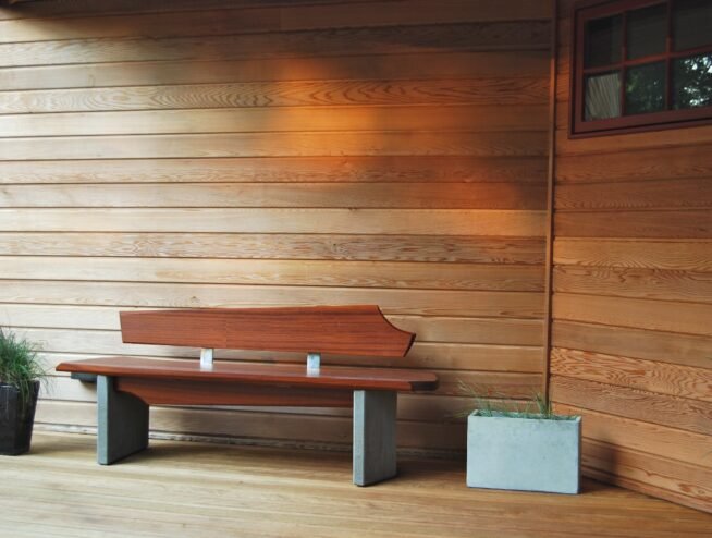 A clean and functional pet waste station with bag dispenser and trash can, professionally installed by Runika.pro in a Miami park or residential community