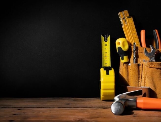 A versatile Runika.pro handyman in Miami efficiently fixing a loose cabinet hinge, a wobbly doorknob, and a small drywall patch in a home