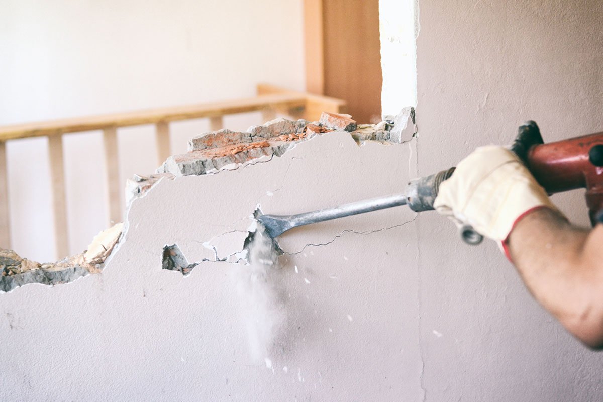Efficient demolition of drywall and studs during a Miami renovation by Runika.pro, with organized debris for easy removal