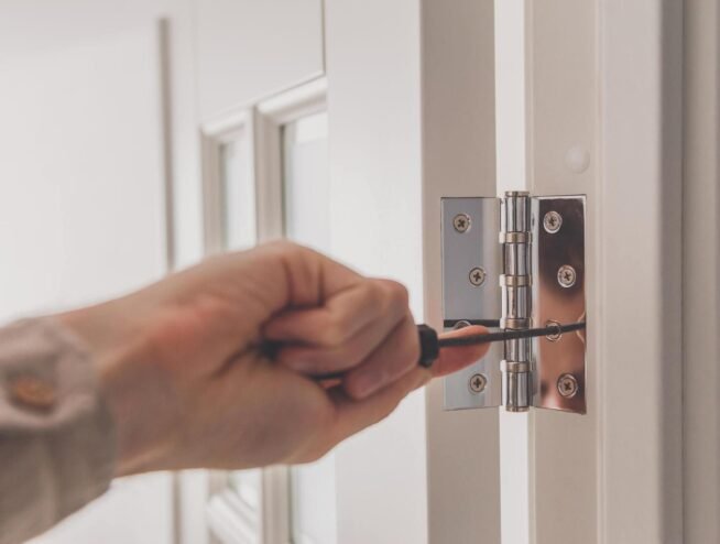 A Runika.pro specialist in Miami installing impact-resistant windows, a secure entry door, and hurricane-rated blockout shutters on a home